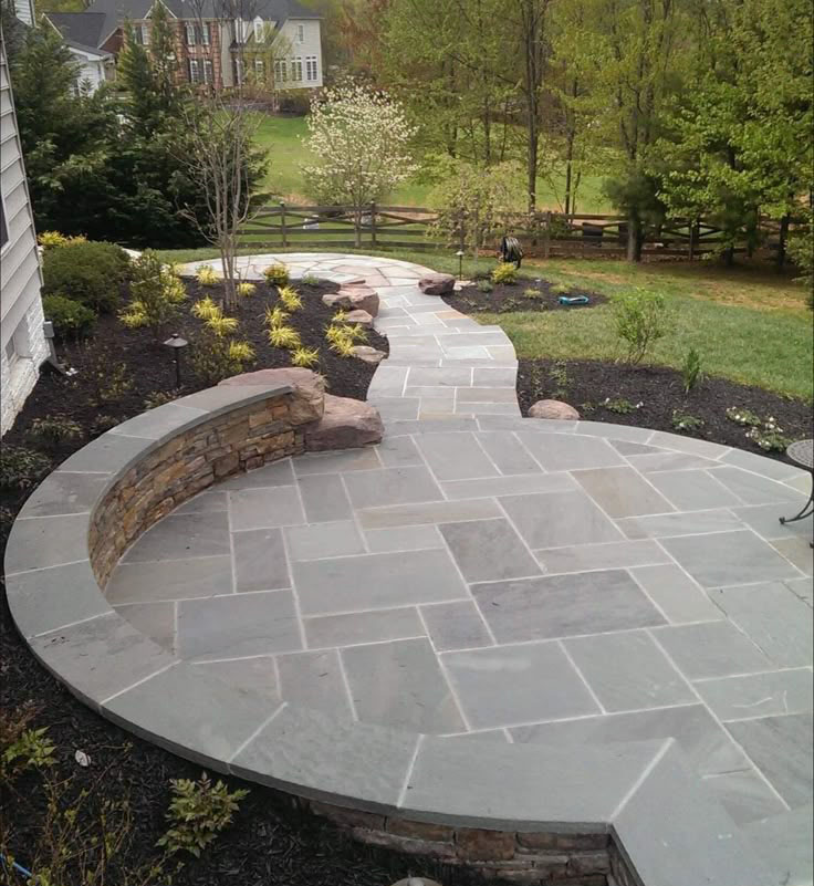 round patio with retaining walls for flower bed